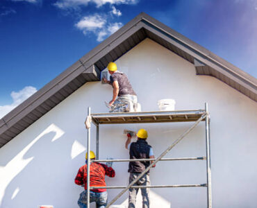 Applying silicone plaster to the wall of the house. Plastering wall.